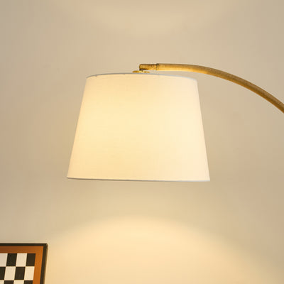 	Curved natural metal floor lamp – ideal for NZ lounges and reading corners