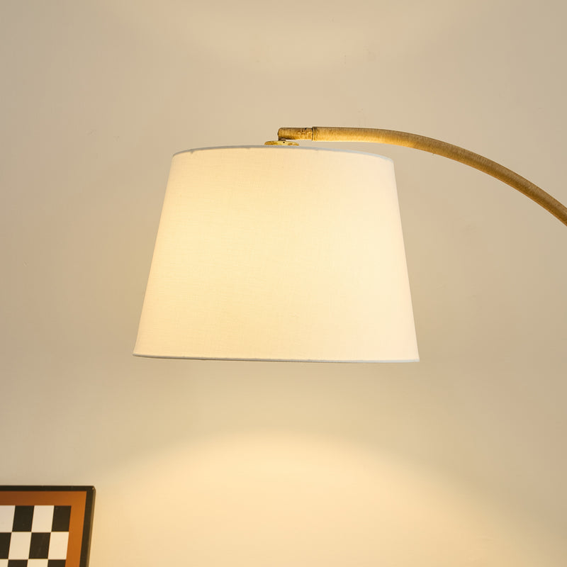 	Curved natural metal floor lamp – ideal for NZ lounges and reading corners