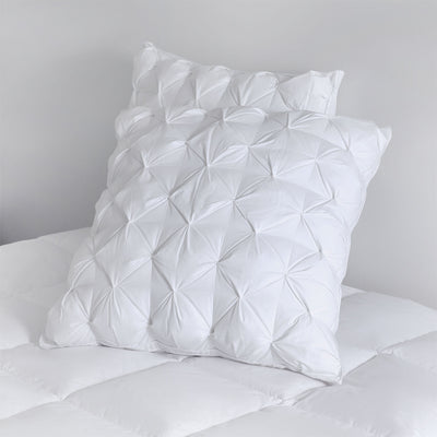 Front view of pinch pleat European pillows showcasing decorative pleat detail

