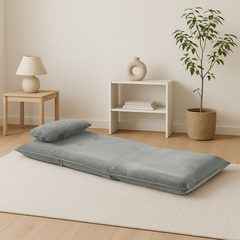 Light grey upholstered single sofa bed offering functionality for small NZ spaces.