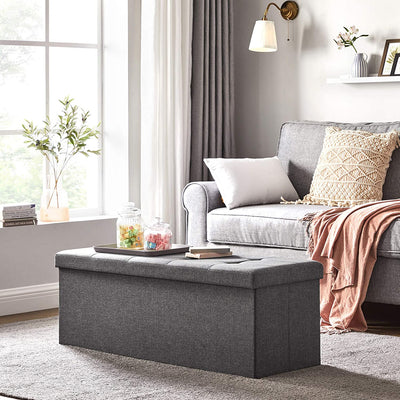 The grey Storage Ottoman Bench placed in a contemporary living room setting, enhancing the room's decor while providing additional seating.